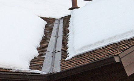The low-voltage RoofHeat STEP roof de-icing system installed under shingles along the roof eave.